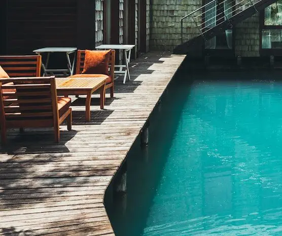 Wooden deck chairs by water