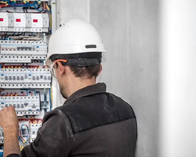 Electrician working on circuit panel