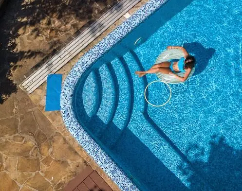 Relaxing poolside in float chair