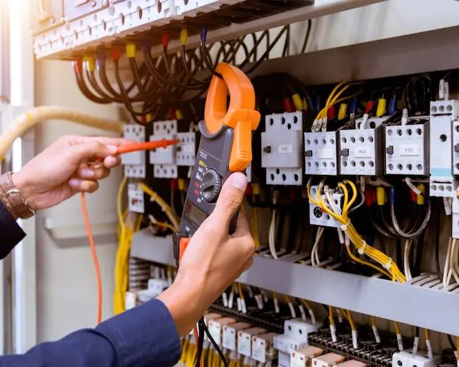 Electrician checking electrical panel wiring