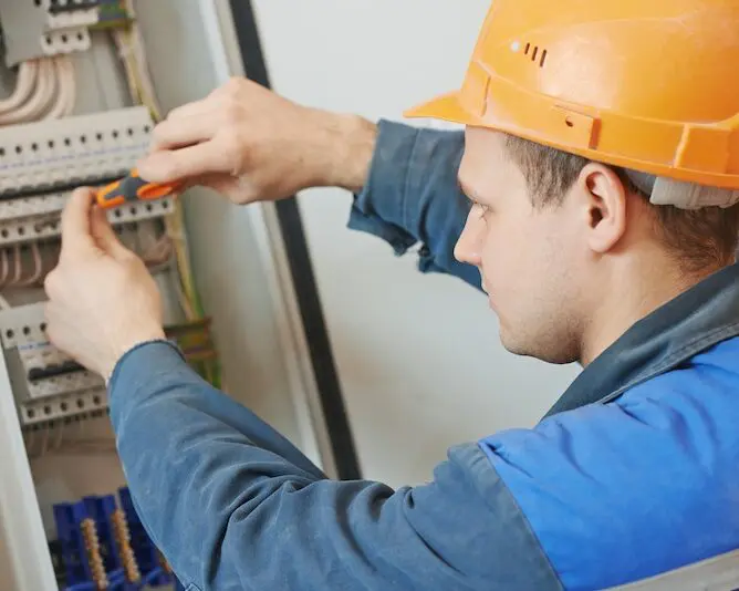 Electrician inspecting circuit panel safety