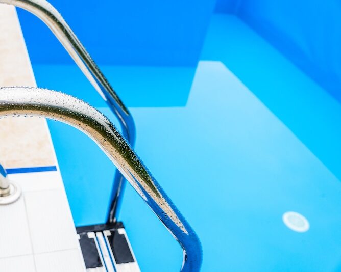 Swimming pool ladder water closeup