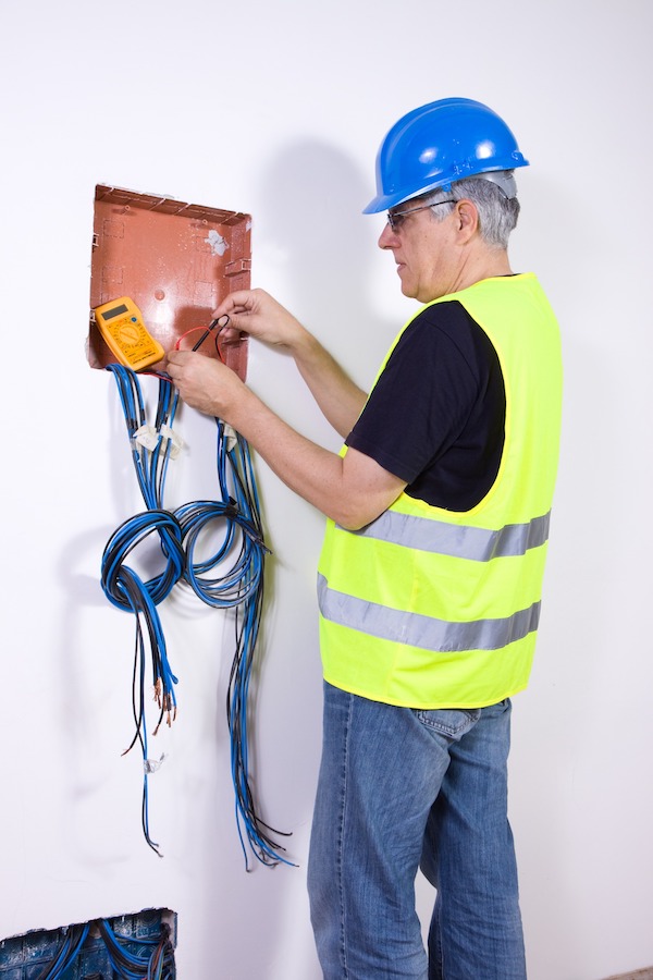 Electrician checking electrical wires installation